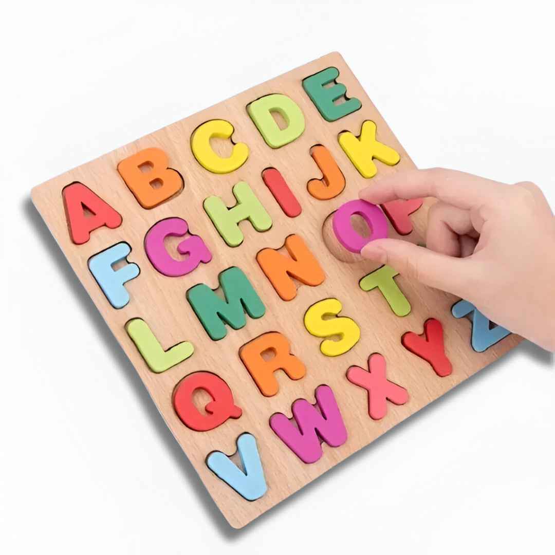 Child’s hand placing wooden letter "O" into alphabet & number puzzle board — fine motor & matching play.