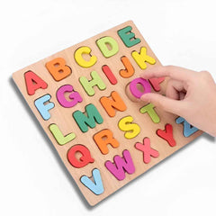 Child’s hand placing wooden letter "O" into alphabet & number puzzle board — fine motor & matching play.