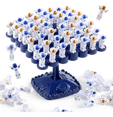 Action shot: astronaut pieces falling from the balance tree during gameplay — shows in-play excitement and loose pieces