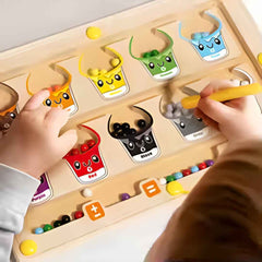 Close-up: magnetic wand lifting beads on the maze — improves hand-eye coordination and precision