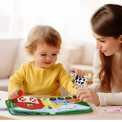 Parent and toddler playing with Busy Farm book and removable animal pieces—parent-child bonding play.